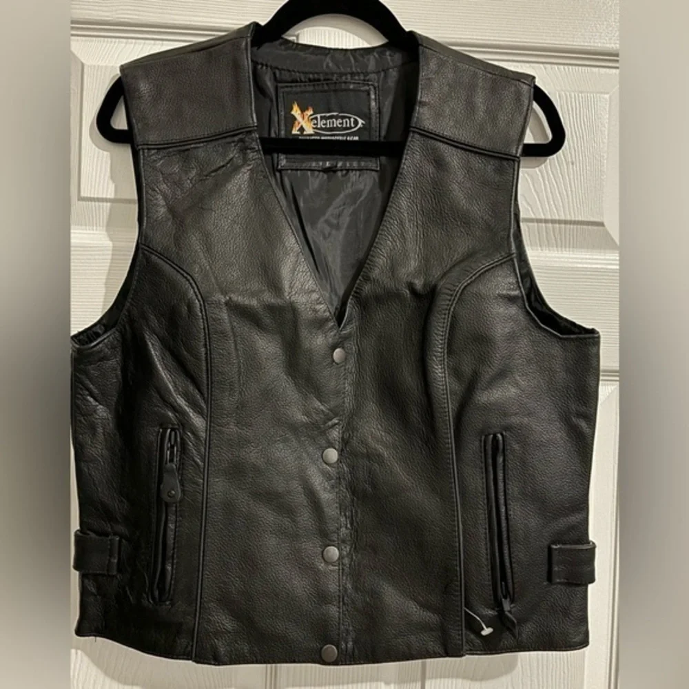 Women”s black Genuine leather V-neck moto vest. Adjustable waist.Zipped packets.